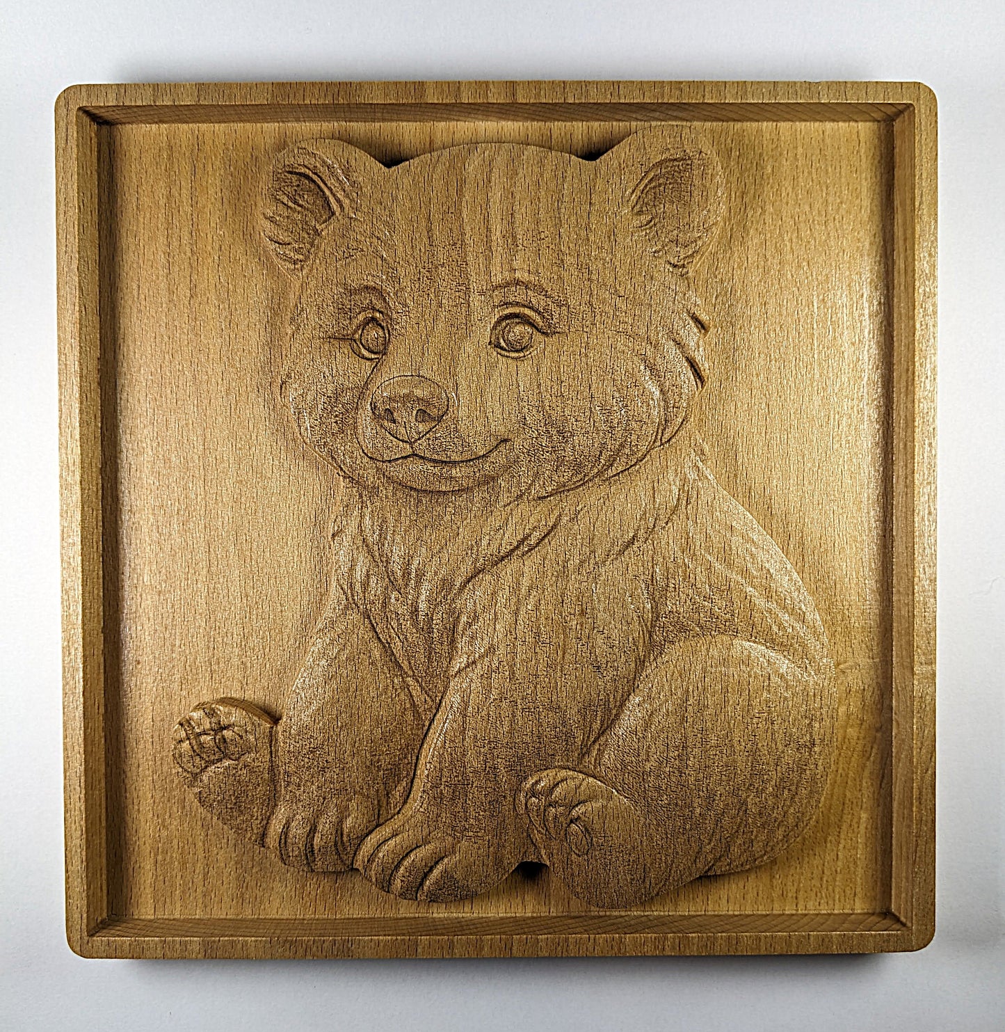 Wooden wall art of bear cub sitting