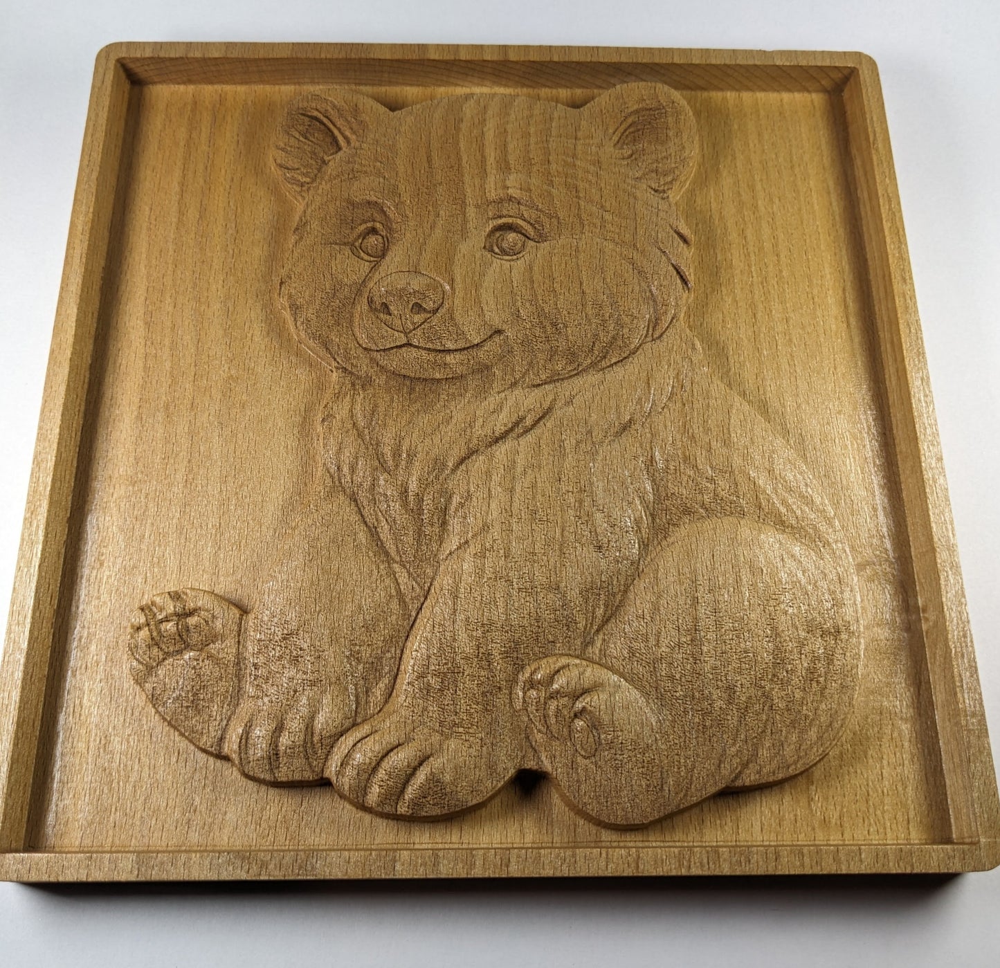 angled view of wooden bear cub art