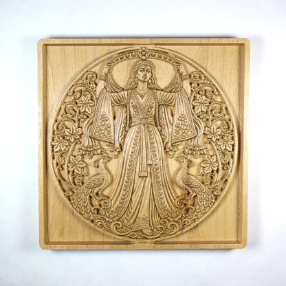 Front view of an Anahita wood relief showing the Persian goddess, floral vines, paired peacocks, round composition, and natural beech wood grain.