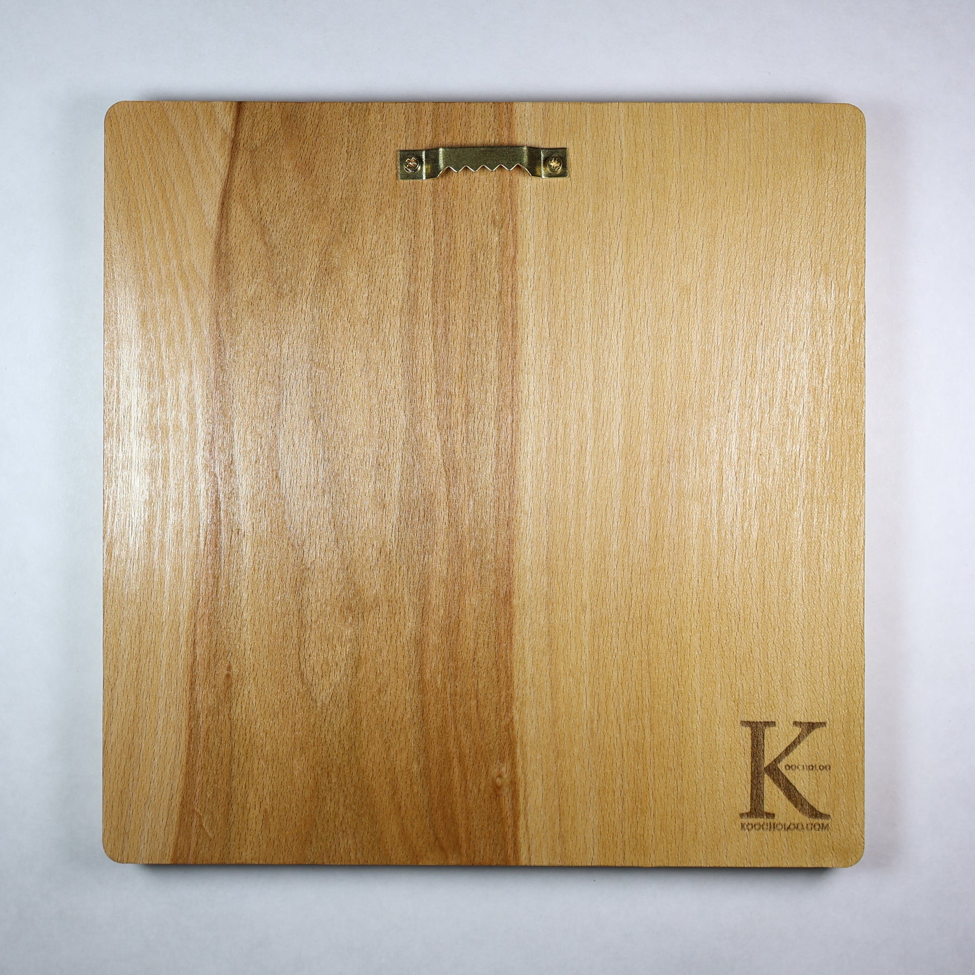 Back view of the Anubis wood relief showing natural wood grain, rounded corners, metal wall hanger, and engraved Koocholoo logo with Koocholoo.com.