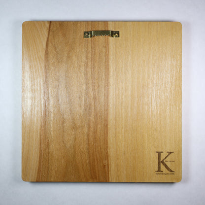 Back view of the Anubis wood relief showing natural wood grain, rounded corners, metal wall hanger, and engraved Koocholoo logo with Koocholoo.com.
