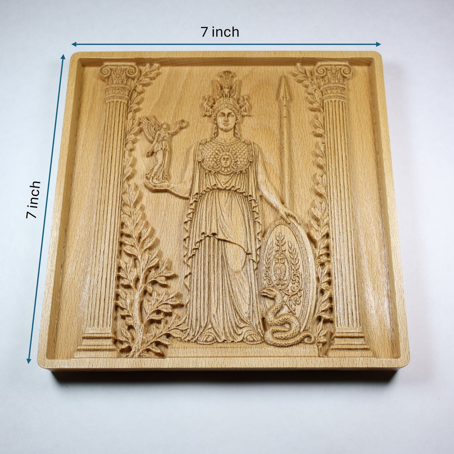 Athena wood relief with 7 inch width and height markers, showing the Greek goddess carving, square frame, and natural wood finish.