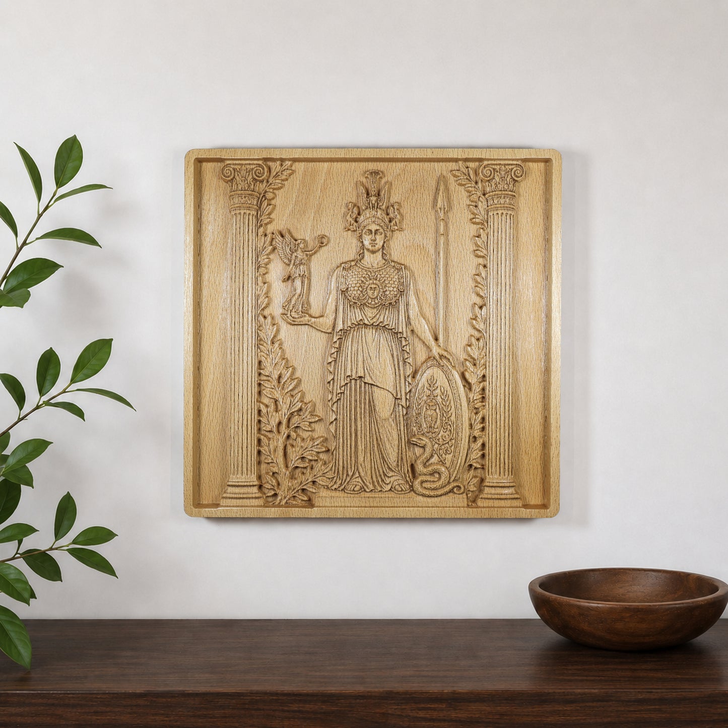 Athena wood relief displayed on a wall above a shelf, showing how the Greek mythology carving looks in a modern interior.