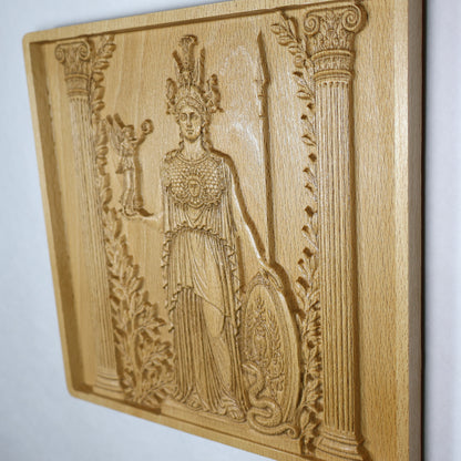 Three-quarter view of the Athena carving showing classical Greek details, olive foliage, raised surfaces, and natural beech wood texture.