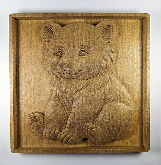 Wooden wall art of bear cub sitting