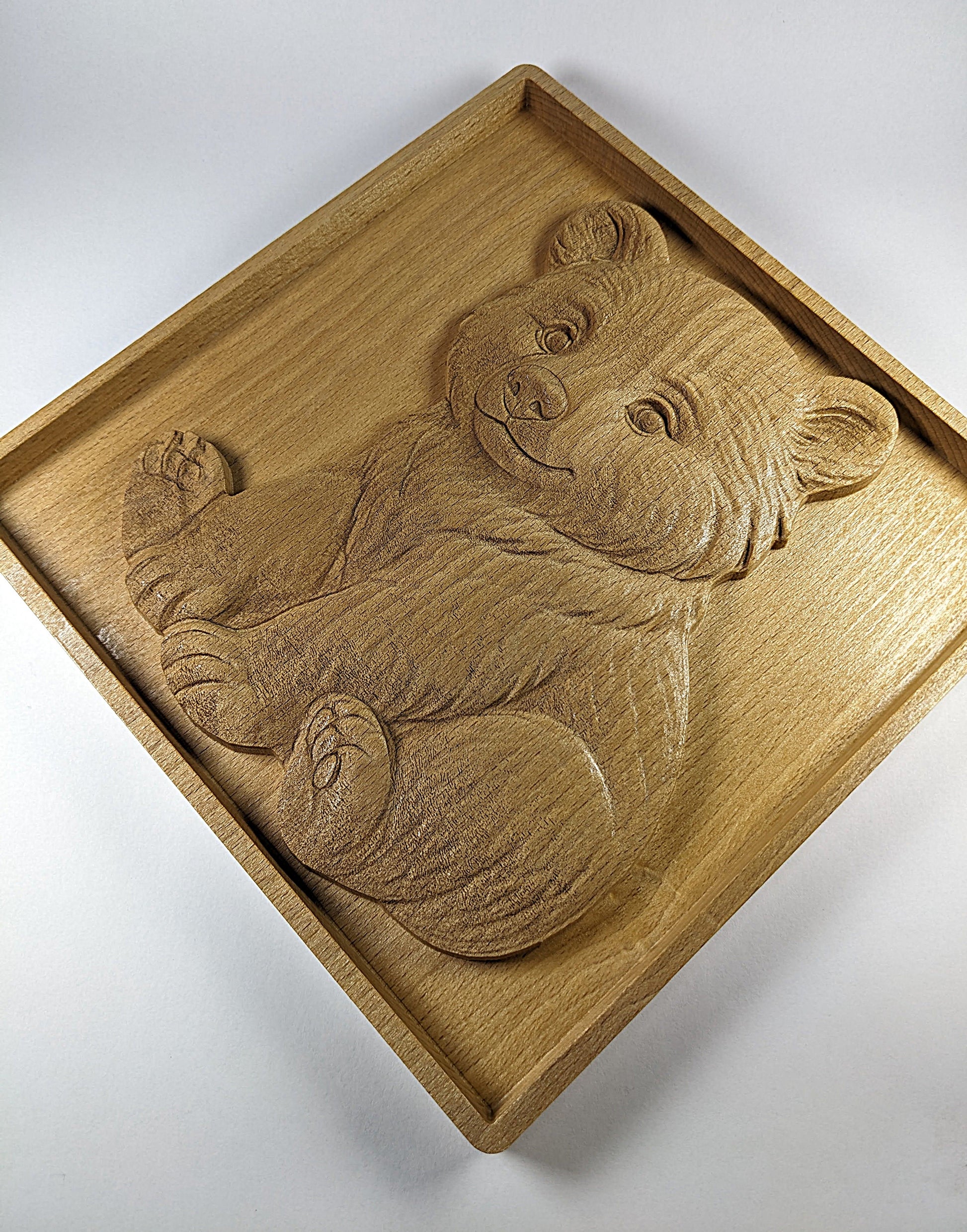 slightly rotated clockwise view of cute sitting bear cub engraving