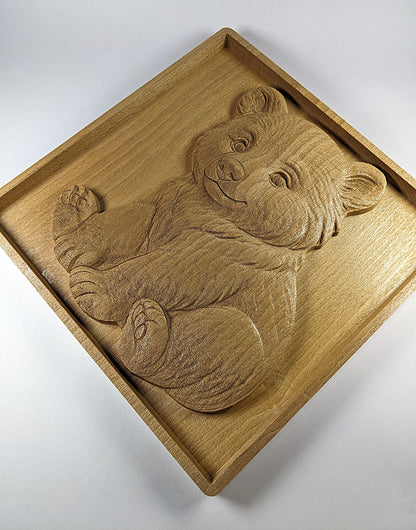slightly rotated clockwise view of cute sitting bear cub engraving