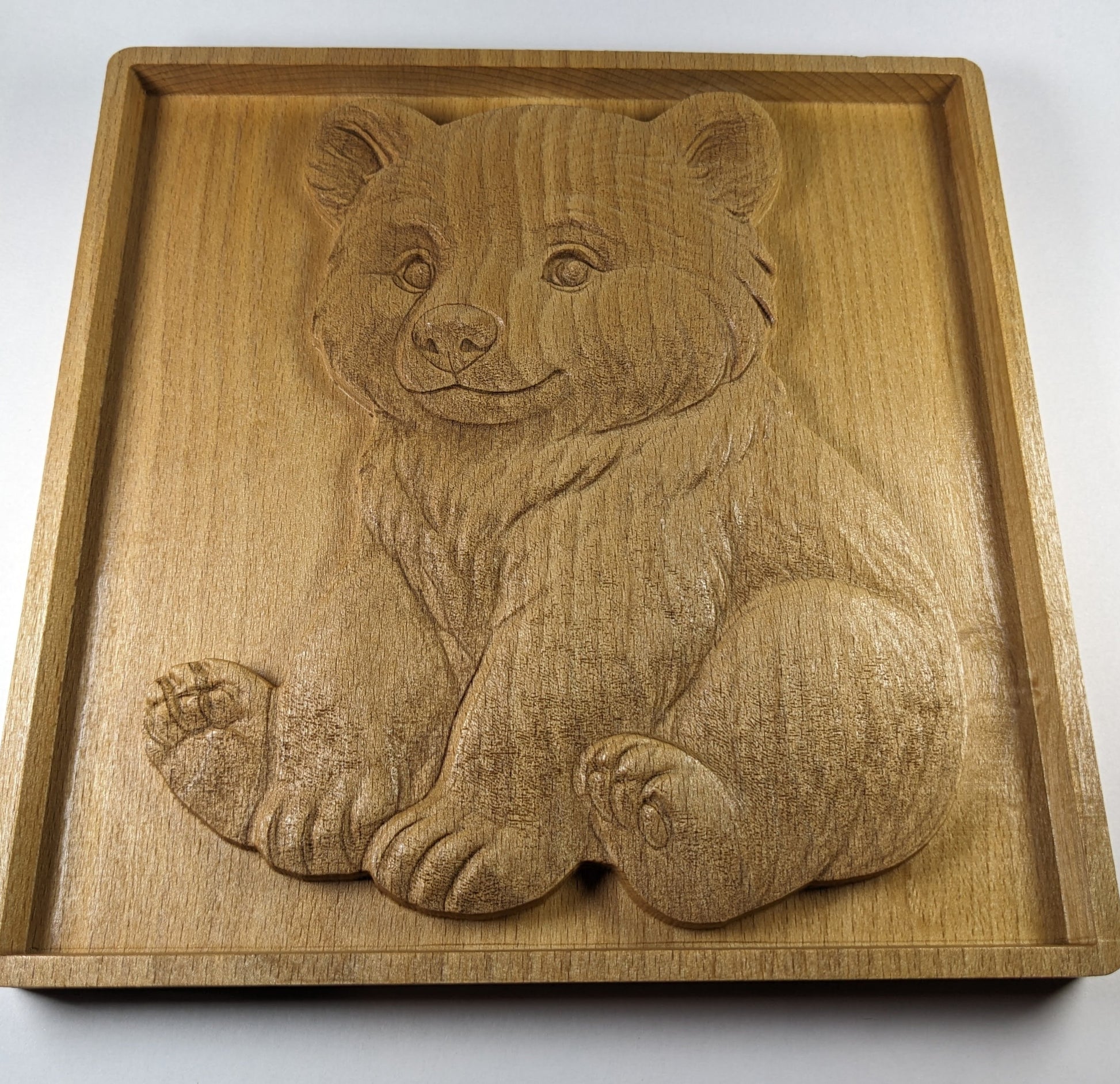 angled view of wooden bear cub art