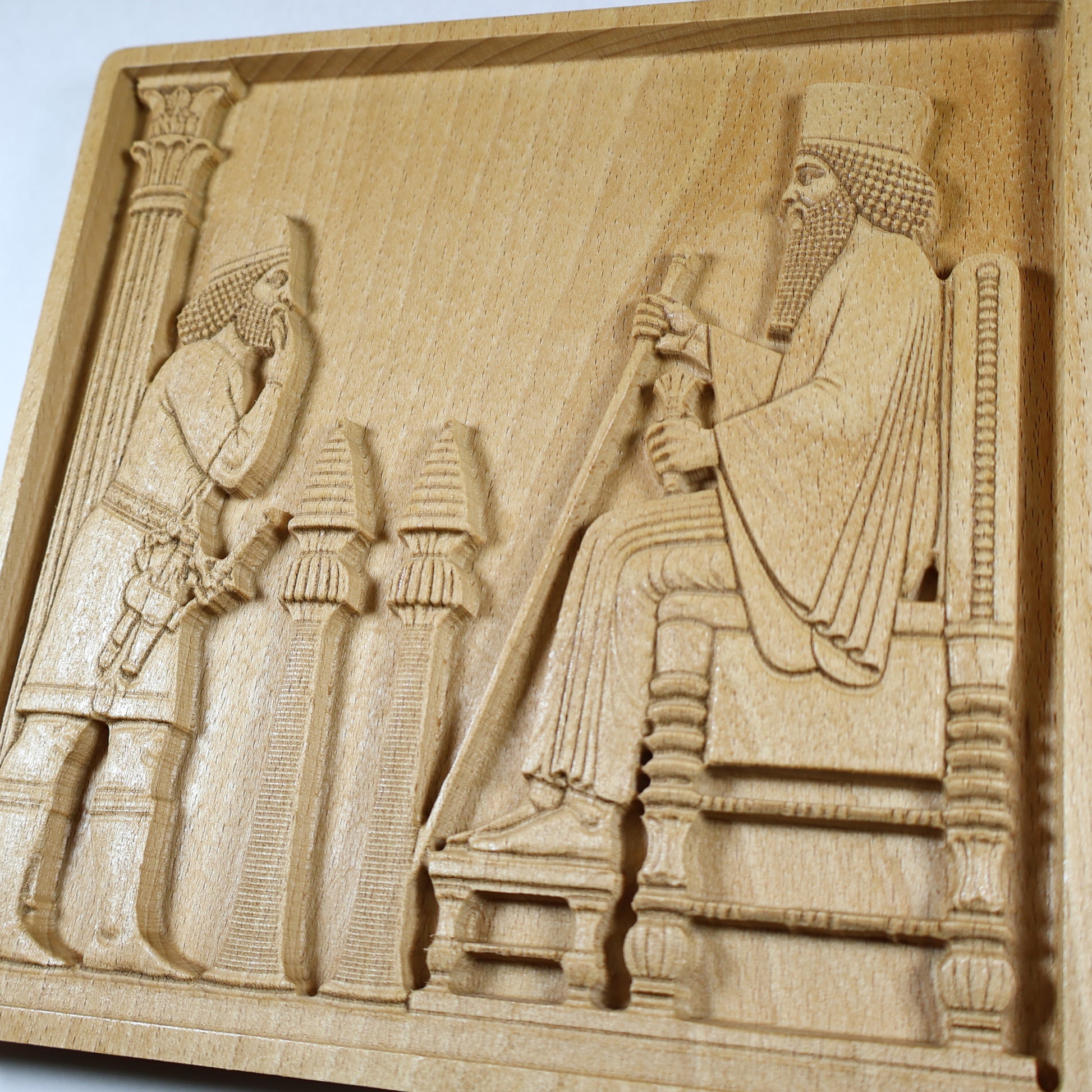 Low angled detail of the Persepolis Royal Audience wood relief showing King Darius, a court attendant, throne steps, column, ceremonial stands, and carved natural wood texture.