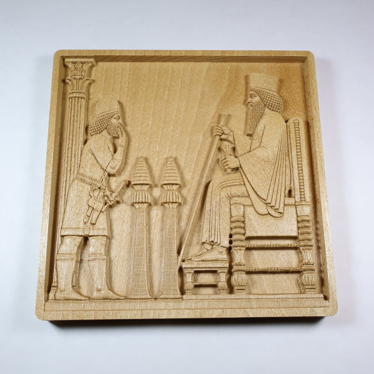 Persepolis Royal Audience wood relief showing King Darius seated on a throne with an attendant, palace column, carved details, and natural beech wood finish.