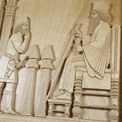 Macro view of the Persepolis Royal Audience wood relief showing King Darius on the throne, an approaching attendant, ceremonial stands, carved robe details, and natural beech wood grain.