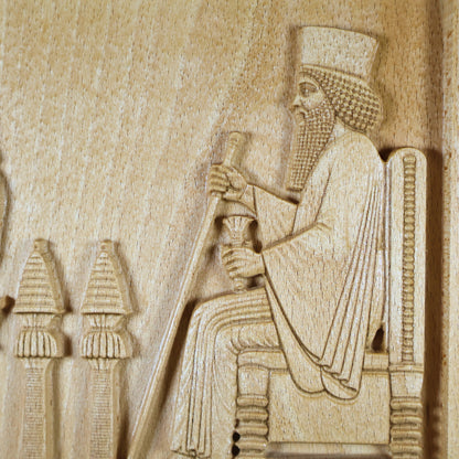 Macro detail of the Persepolis Royal Audience wood relief showing King Darius seated on the throne with staff and cup, ceremonial stands, carved robe lines, and natural beech wood finish.