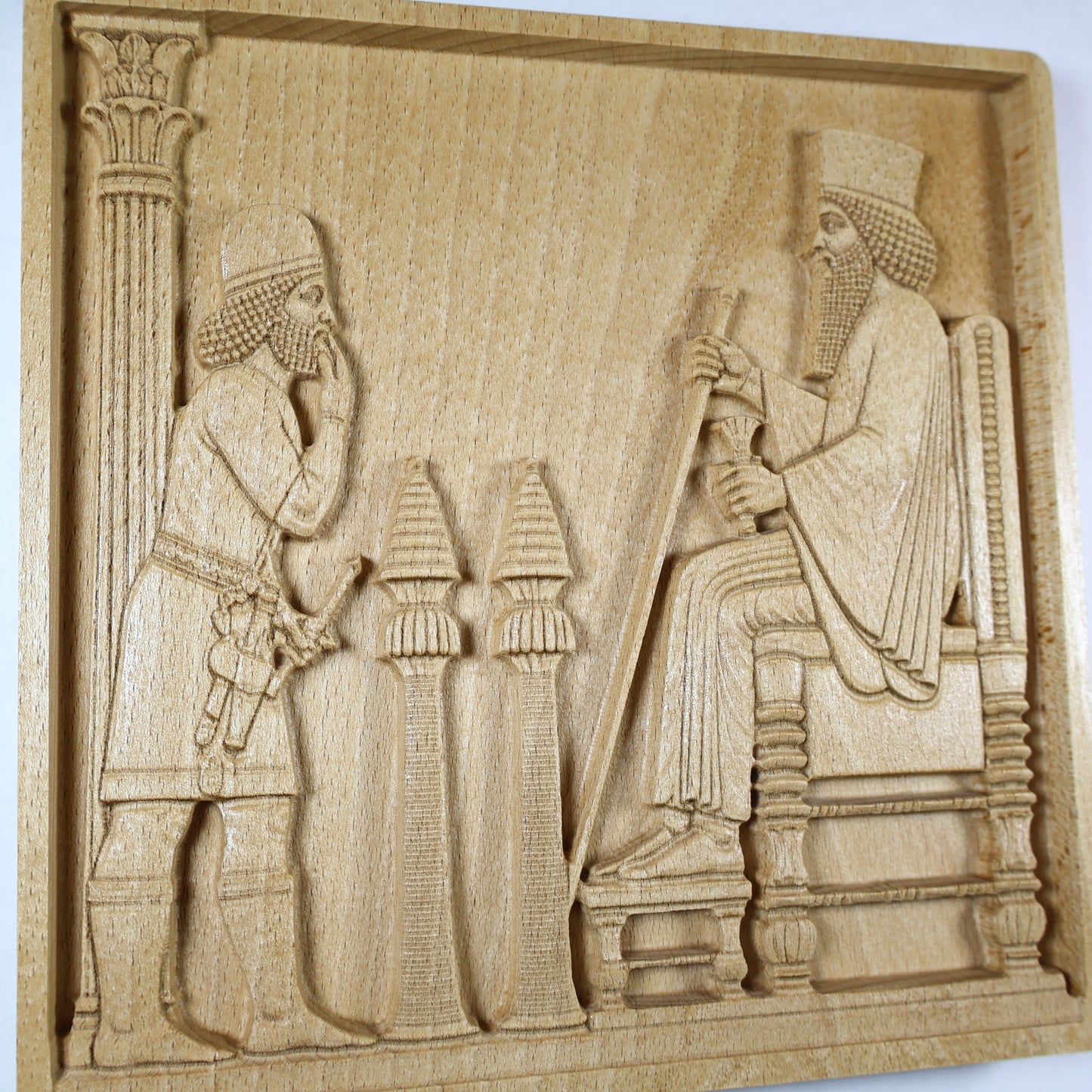 Angled product photo of the Persepolis Royal Audience wood relief showing a seated Persian king, respectful attendant, carved column, ceremonial stands, throne details, and natural wood finish.