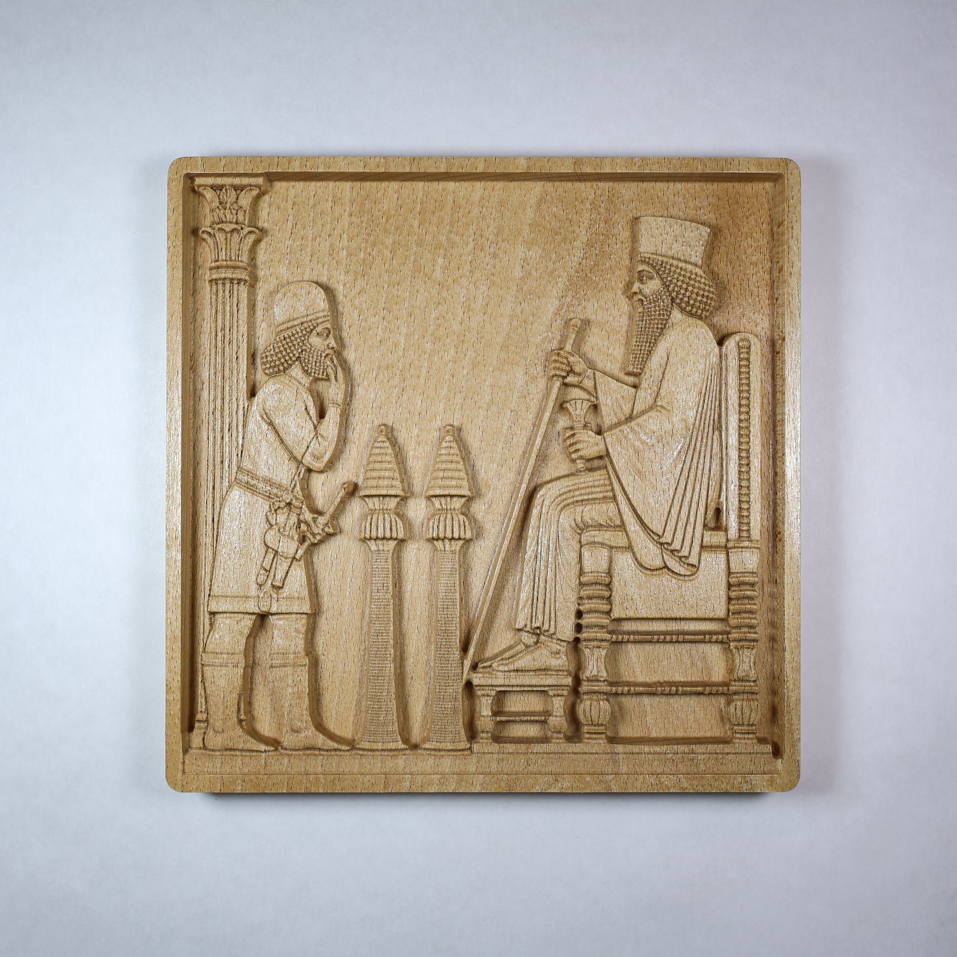 Front view of a Persepolis Royal Audience wood relief showing a seated Persian king, approaching figure, palace columns, throne details, and natural beech wood finish.