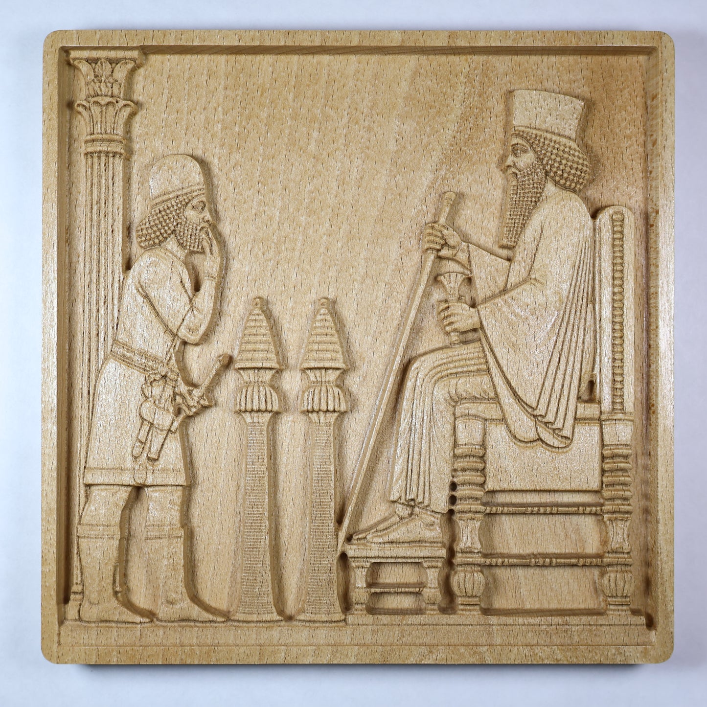 closed up Front view of a Persepolis Royal Audience wood relief showing a seated Persian king, approaching figure, palace columns, throne details, and natural beech wood finish.