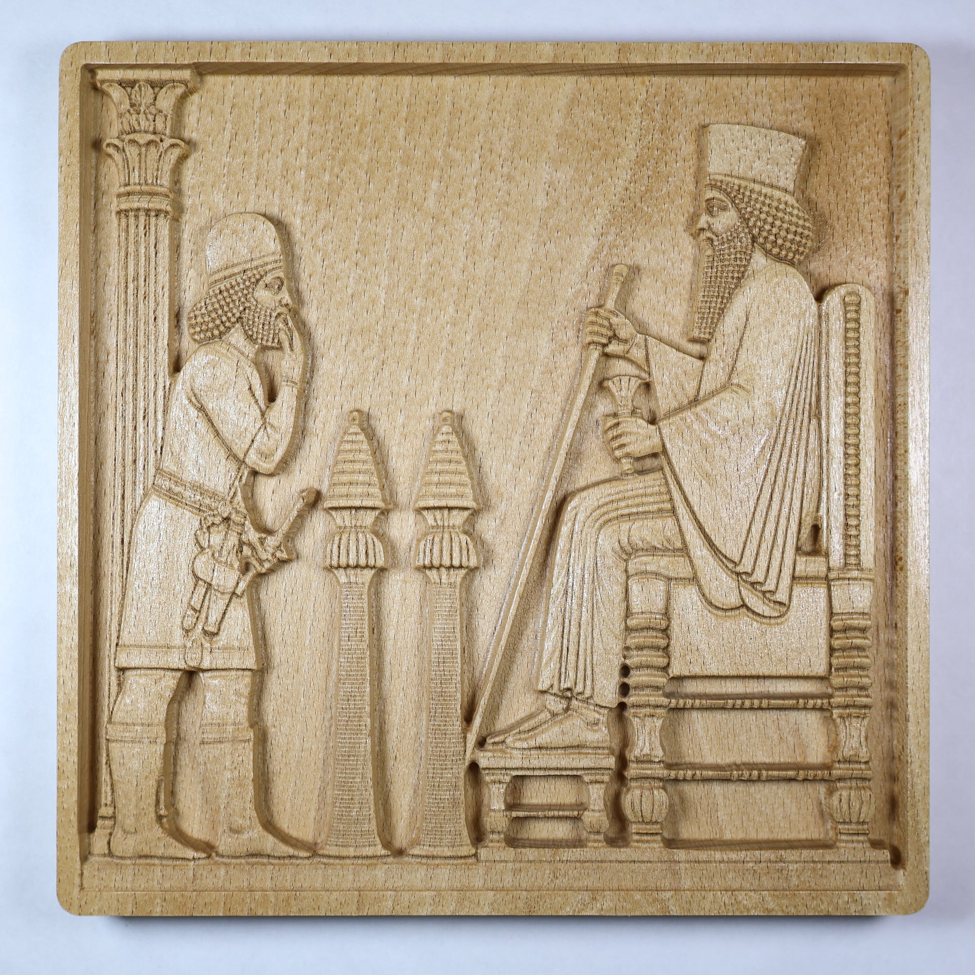 closed up Front view of a Persepolis Royal Audience wood relief showing a seated Persian king, approaching figure, palace columns, throne details, and natural beech wood finish.