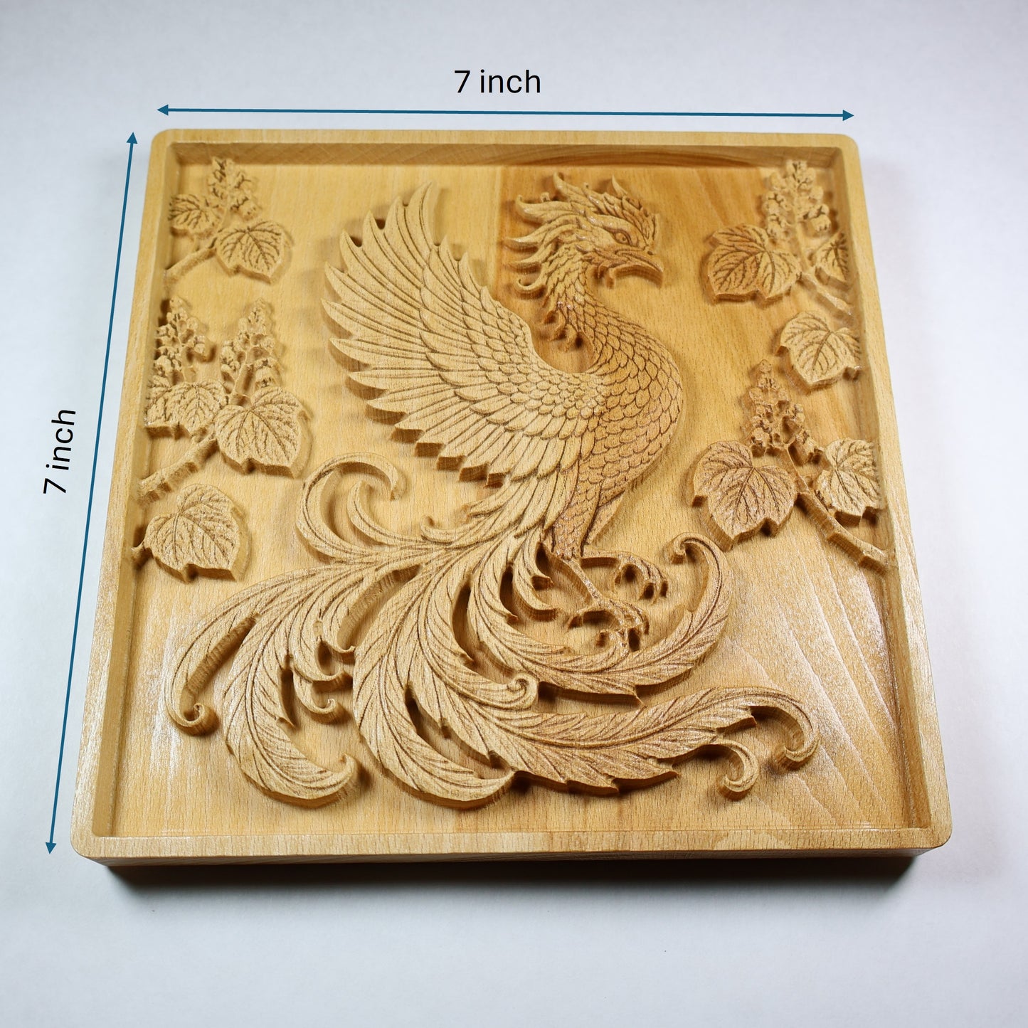 Japanese Phoenix wood relief with 7 inch width and height markers, showing the carved Hoo bird, paulownia branches, square frame, and natural wood finish.