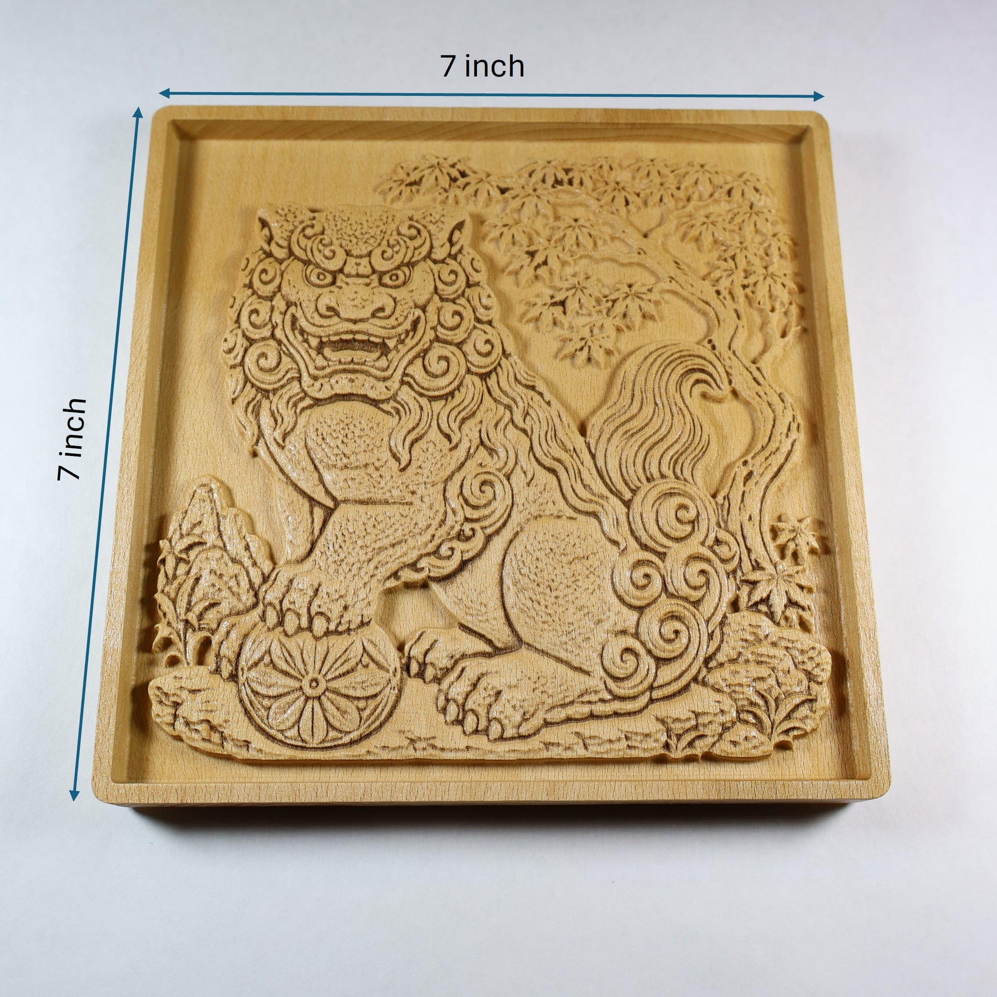 Japanese Komainu wood relief shown with 7 inch width and height markers, featuring a carved guardian lion dog, floral ball, maple tree, and natural wood finish.
