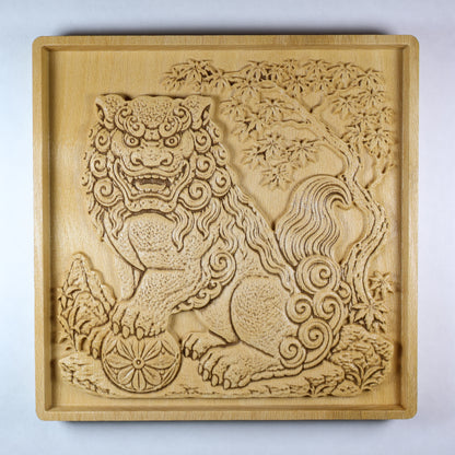 Front view of a Japanese Komainu guardian lion dog wood relief with a carved floral ball, curled mane, maple tree background, square frame, and natural wood finish.