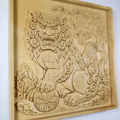 Side-angle view of a Japanese Komainu wood relief showing the raised carving depth, fierce guardian face, flower ball, curled tail, maple leaves, and natural wood finish.