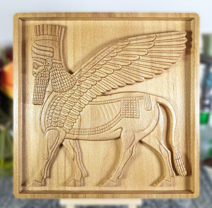 Hand-finished CNC-carved beech wood bas relief of Lamassu, Assyrian protective deity, front-facing view showing carved wing detail, beard, and crown, 3D wood wall art