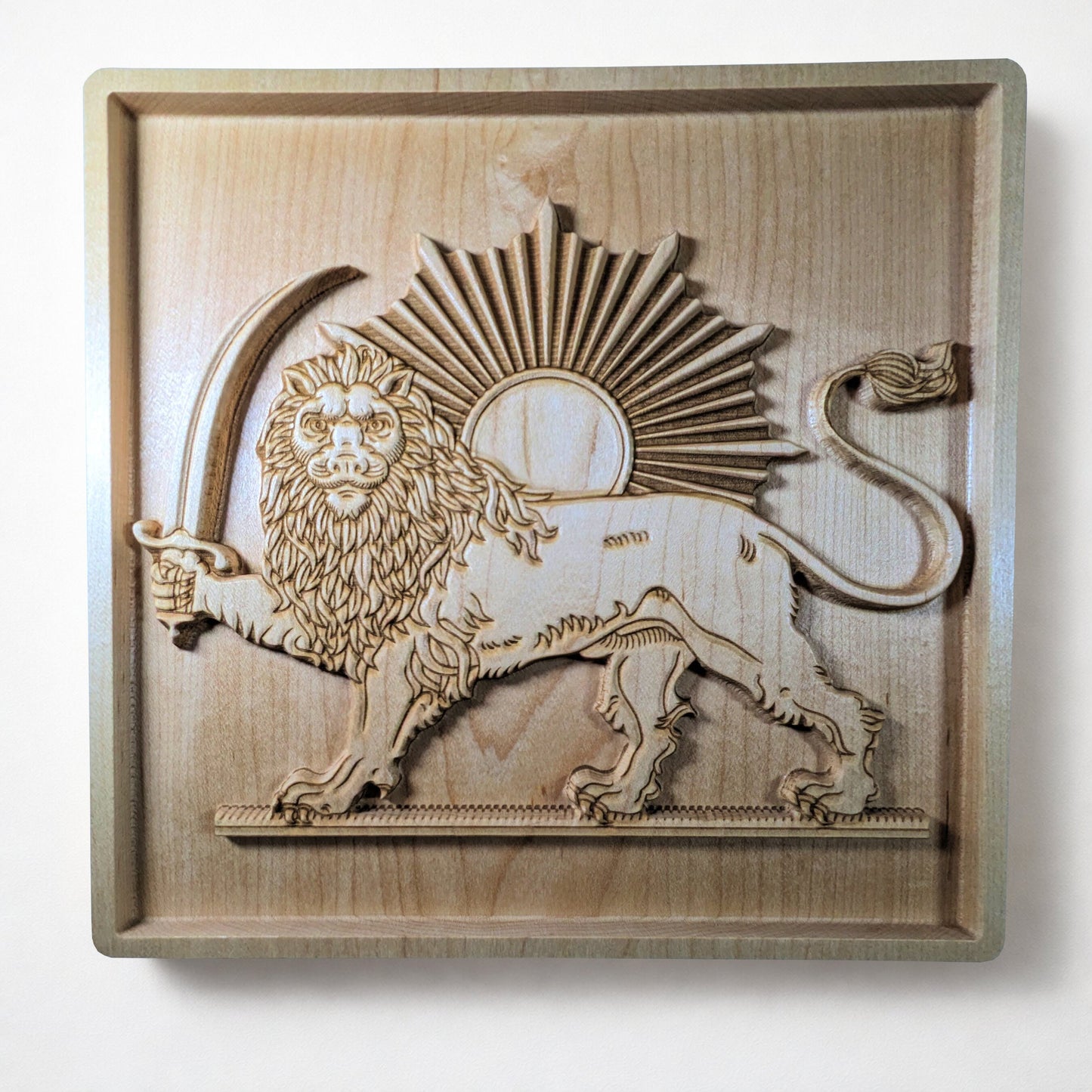Front view of Lion and Sun (Shir va Khorshid) carved hard maple wood wall art, full relief panel with raised lion, curved saber, sunburst, and framed border, Persian heritage wall decor