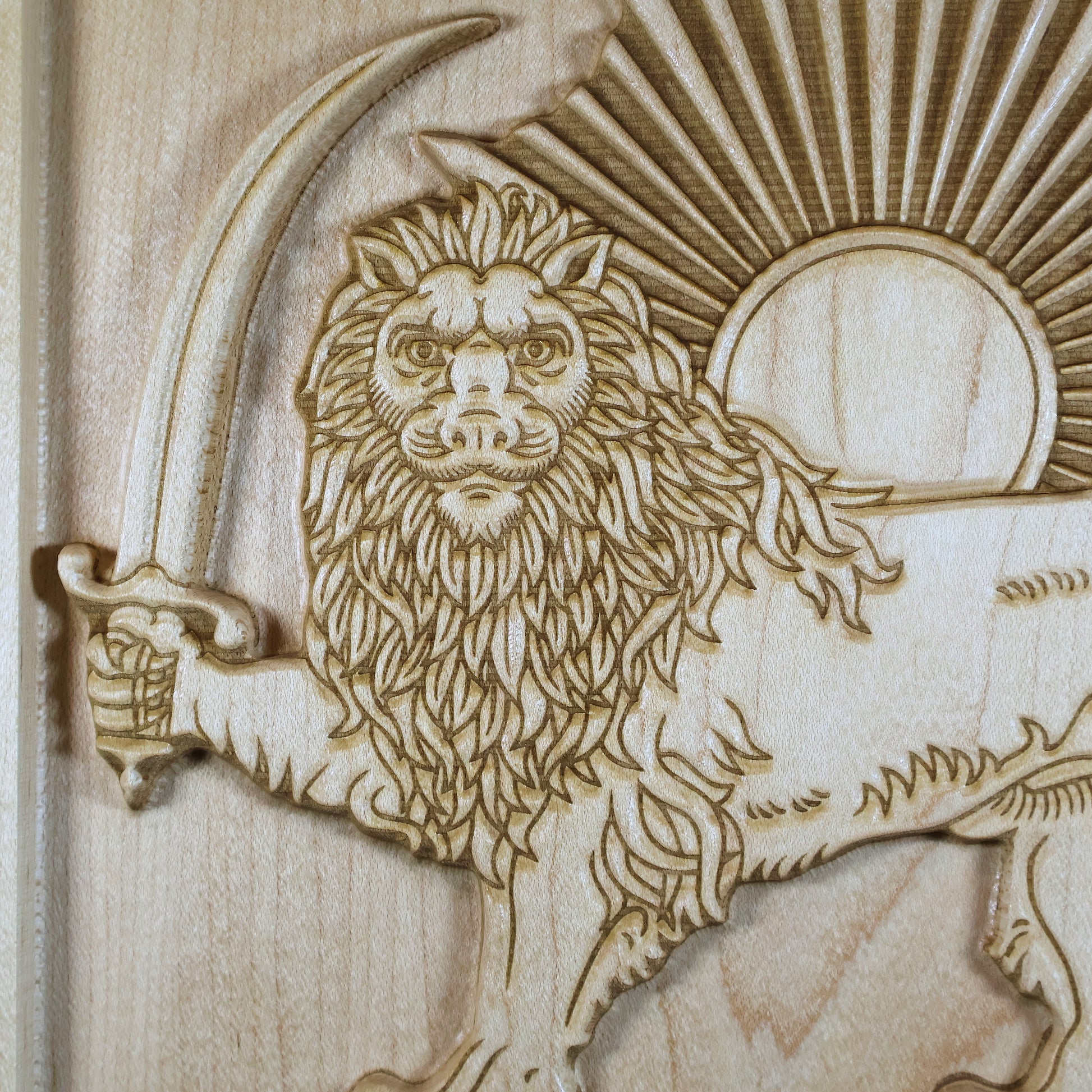 Macro detail of the Lion and Sun relief showing the lion face, crown, mane, sword, sun disk, and precision-carved rays.