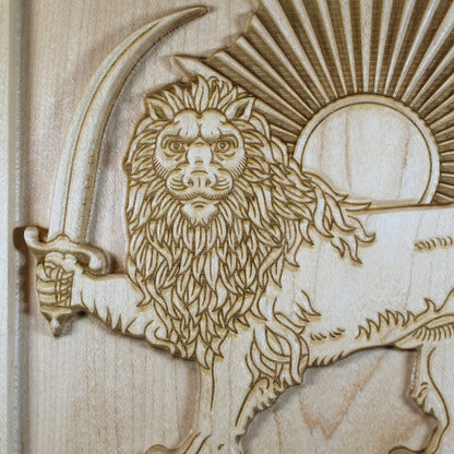 Macro detail of the Lion and Sun relief showing the lion face, crown, mane, sword, sun disk, and precision-carved rays.