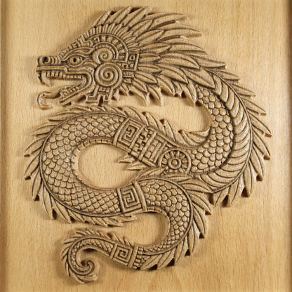 Full front detail of Quetzalcoatl carved beech wood relief, complete coiled feathered serpent with open jaw, spiral cheek disc, layered plume crest, fish-scale body, meander band collar, and curled tail on warm wood grain