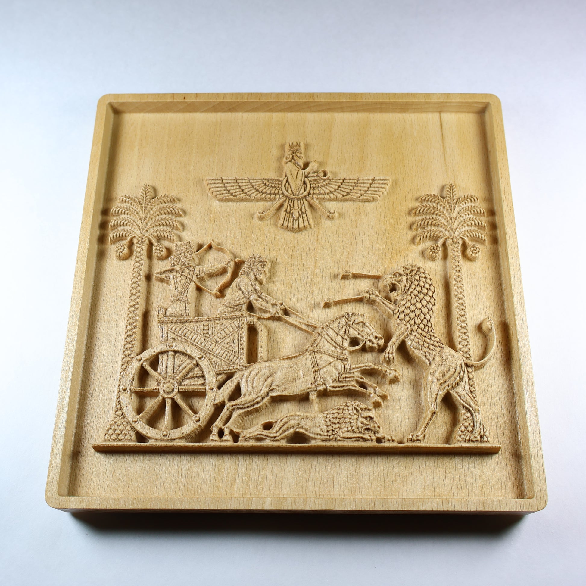 Low angled view of the Darius lion hunt relief showing the raised chariot, horses, lions, palm trees, and dimensional wood carving.
