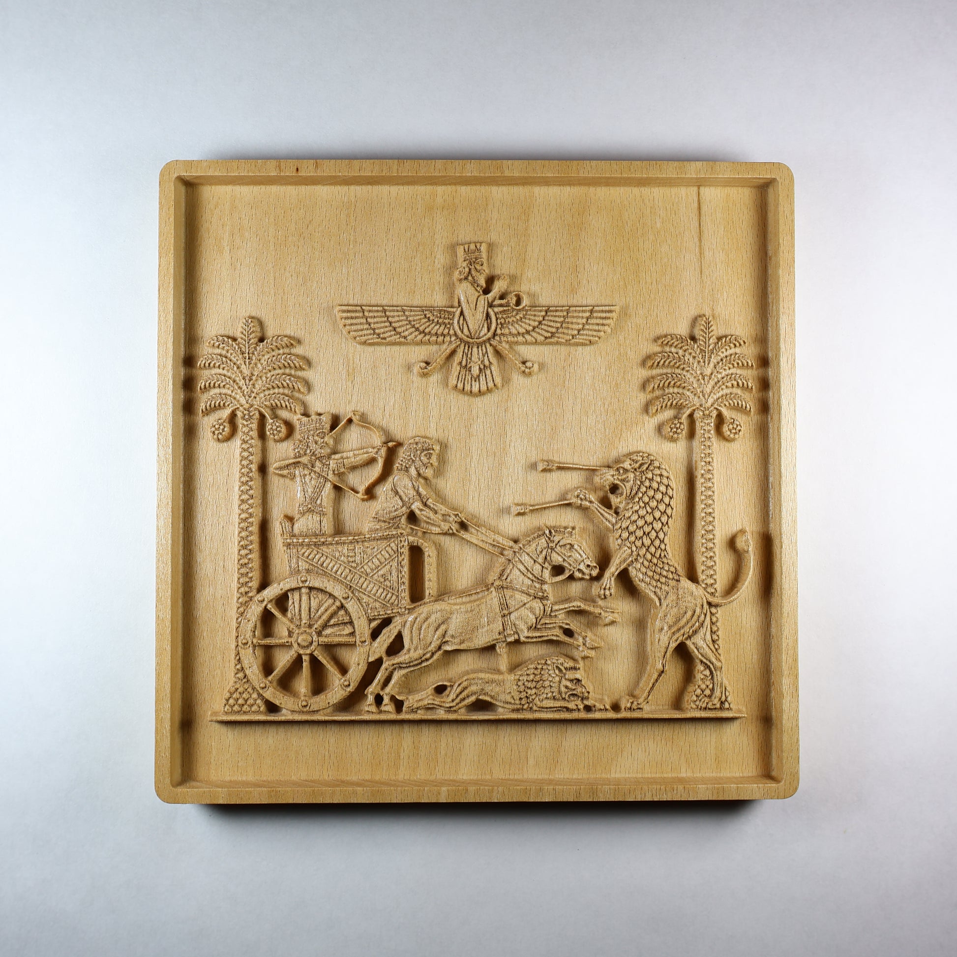 Front view of the Royal Seal of Darius wood relief showing a Persian royal chariot, two horses, hunting lion, date palms, winged symbol, and natural wood finish.