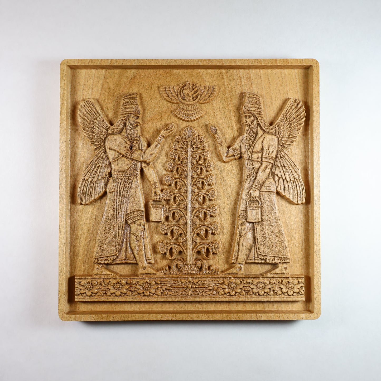 Front view of Assyrian Sacred Tree wood relief with mirrored Apkallu guardian figures, winged sages flanking central tree, Ashur winged disc above, CNC-carved solid beech wood, 7x7 inch Mesopotamian wall art