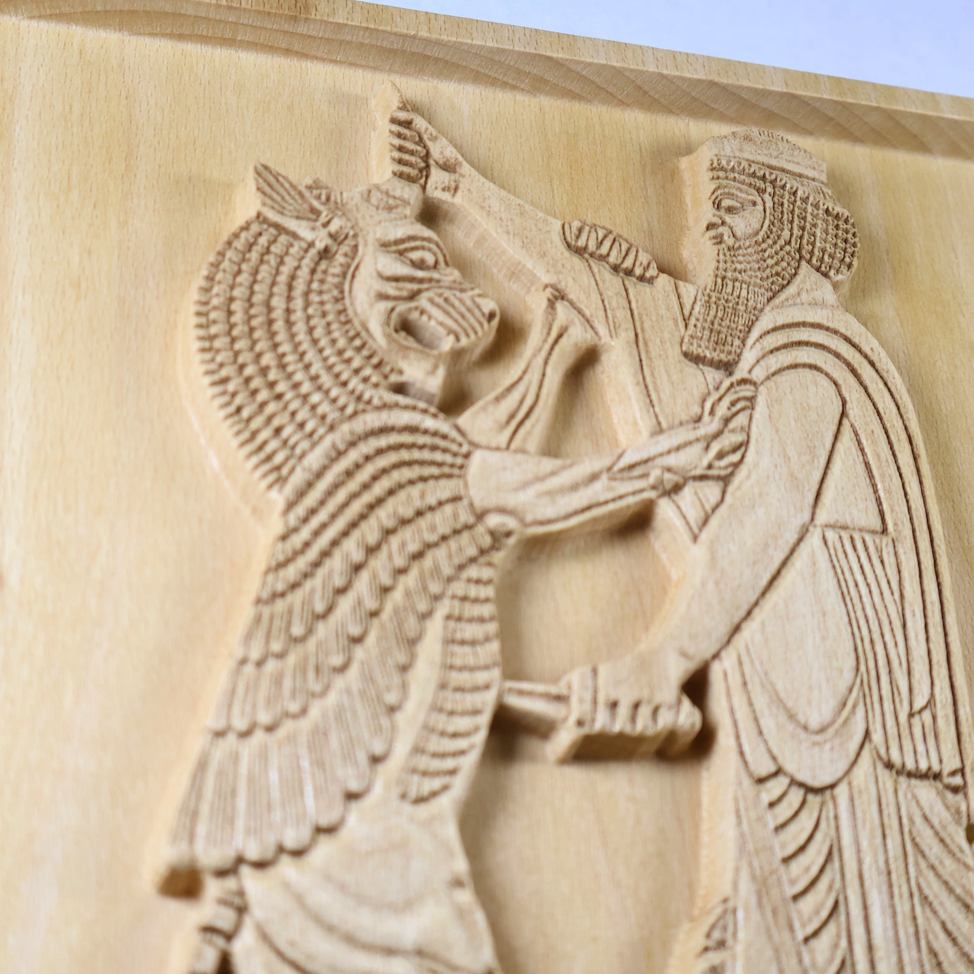 Macro side view of Shahriar and the Lion wood relief showing the carved lion, Persian figure, dagger, beard detail, robe lines, and raised natural wood relief.