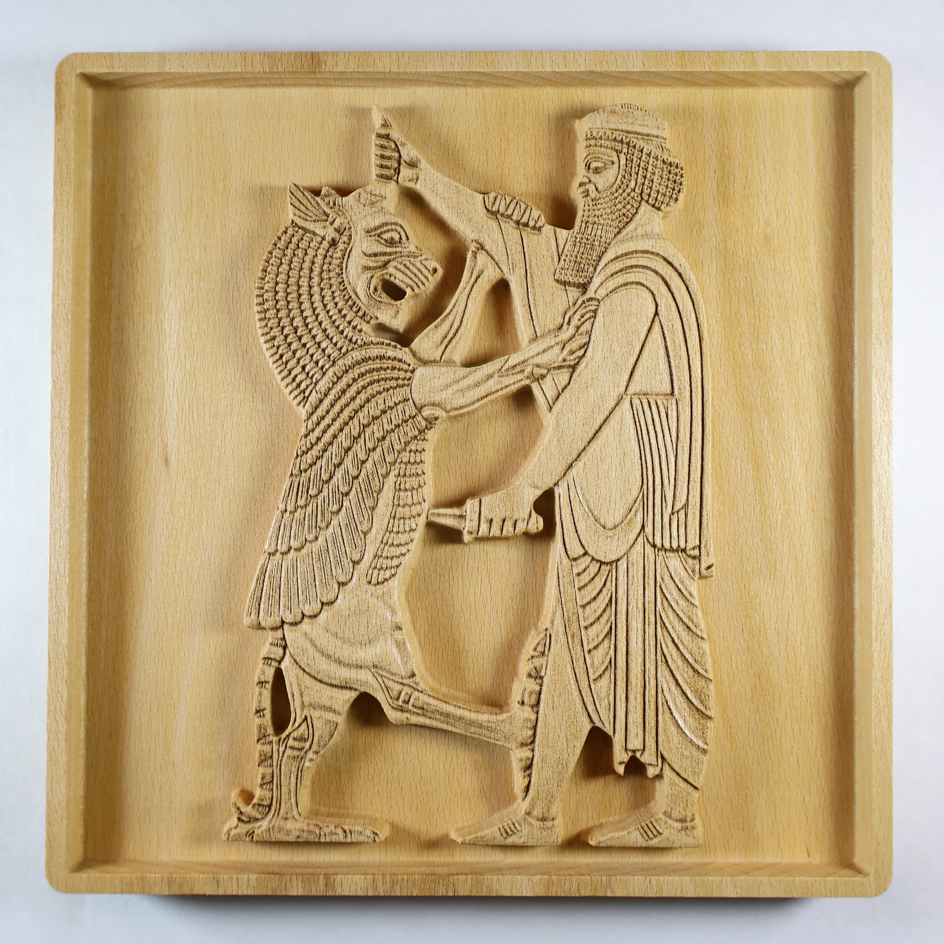 Straight-on view of Shahriar and the Lion wood relief, showing the centered Persian figure and rearing lion with carved robe, beard, mane, and natural wood finish.