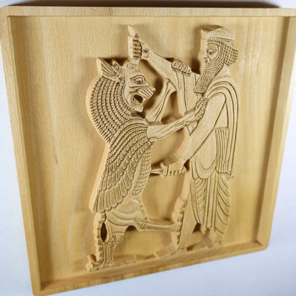 Side perspective of Shahriar and the Lion wood relief showing the raised Persian figure and lion carving, recessed square frame, carved robe lines, weapon detail, and natural beech wood finish.