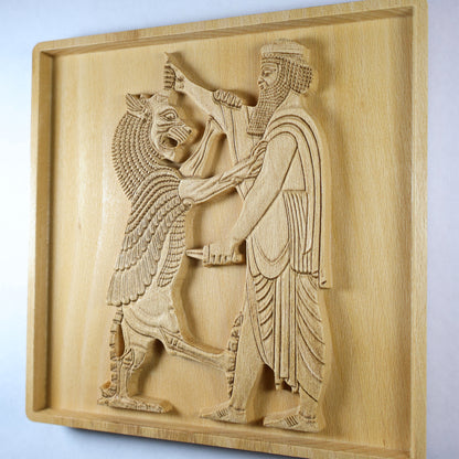 Right-side angle of Shahriar and the Lion wood relief showing the raised Persian figure and lion scene, carved blade, robe details, recessed frame, and natural beech wood finish.