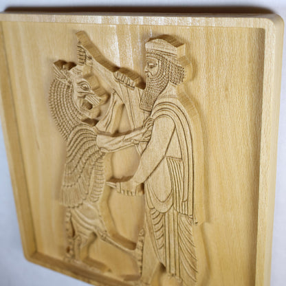 Extreme side-angle view of Shahriar and the Lion wood relief showing the raised carving depth, bearded Persian figure, lion, robe details, shadowed cutouts, and rounded wood frame.