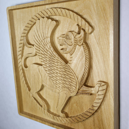 Side view of an Achaemenid winged lion wood relief showing raised carving depth, shadowed edges, roundel details, and polished natural wood.