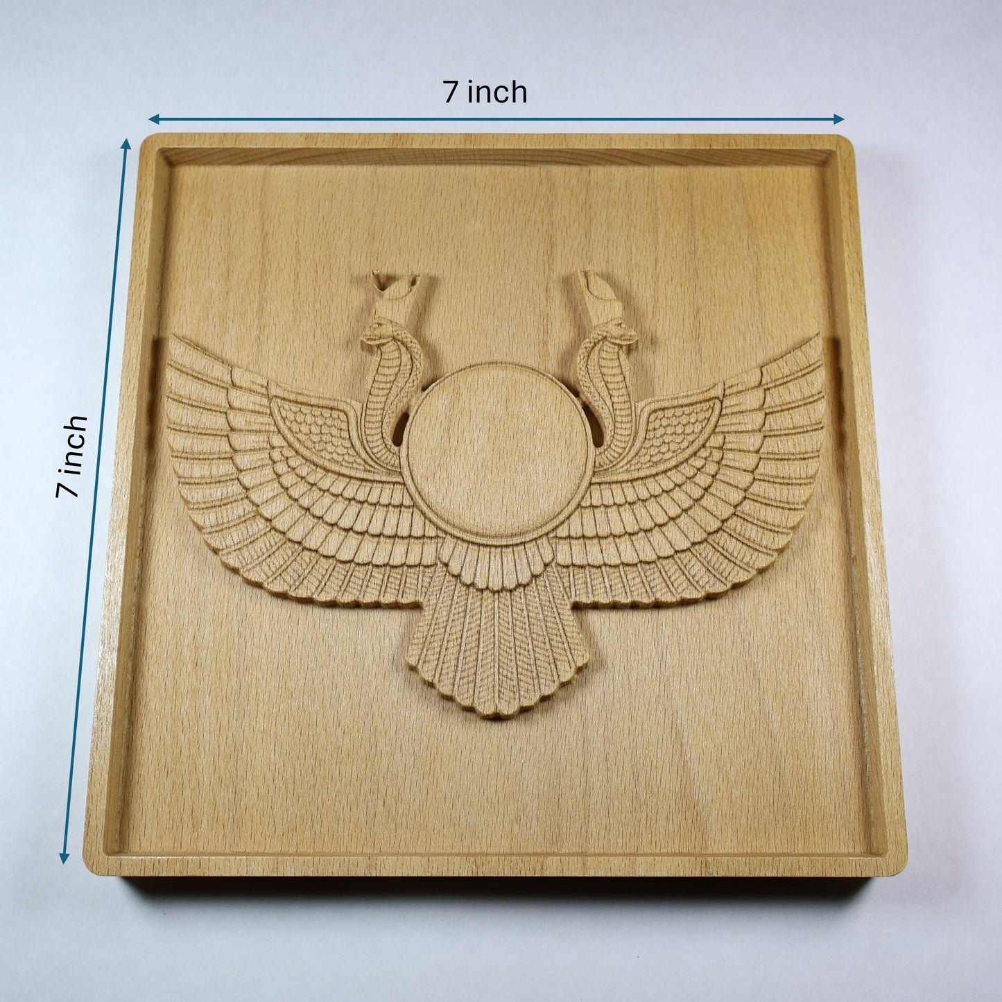 Egyptian Winged Sun Disk wood relief with 7 inch width and height markers, showing the central sun disk, twin cobras, feathered wings, square frame, and natural beech wood finish.
