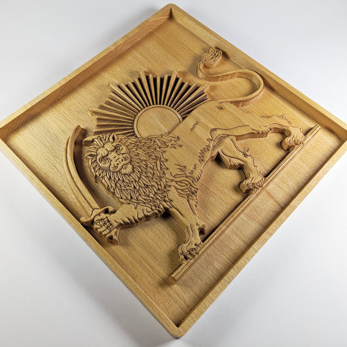 Diagonal view of Lion and Sun wood wall art carved in solid beech, showing the raised lion figure, sword, curled tail, sunburst rays, square framed border, warm wood grain, and 3D Persian carved wood relief depth.
