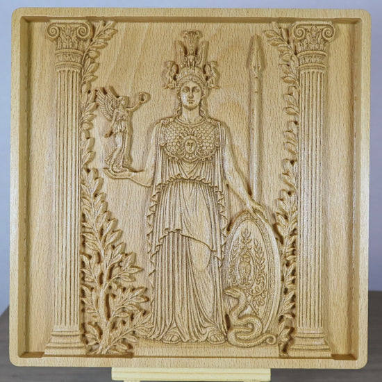 Rotating tabletop video of the Athena wood relief, showing front and angled side views of the Greek goddess, carved shield, spear, owl, olive branches, classical details, raised relief depth, and natural beech wood finish.