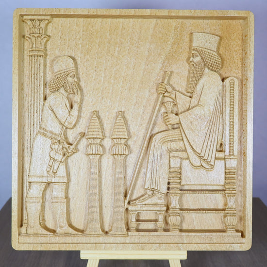 Rotating tabletop video of the Persepolis Royal Audience wood relief, showing the front and angled side views of the Achaemenid palace scene with King Darius on a throne, an approaching attendant, carved columns, Persian bas relief depth, and natural beech wood finish.
