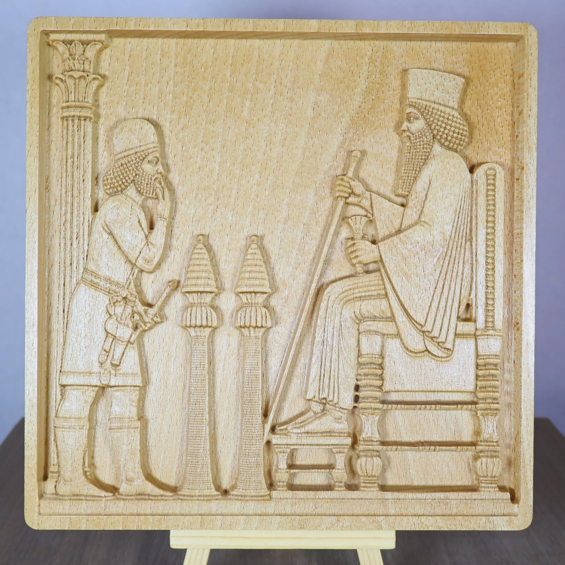 Rotating tabletop video of the Persepolis Royal Audience wood relief, showing the front and angled side views of the Achaemenid palace scene with King Darius on a throne, an approaching attendant, carved columns, Persian bas relief depth, and natural beech wood finish.