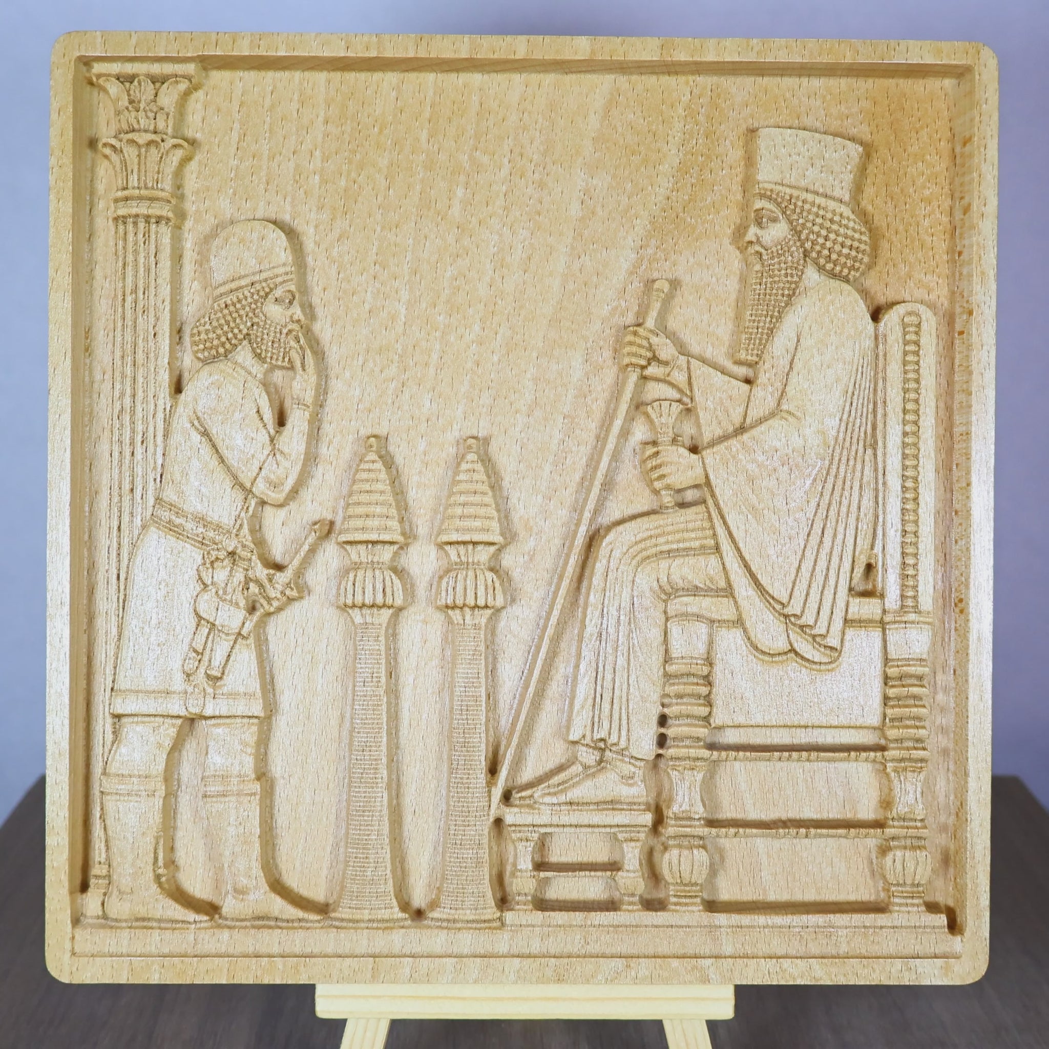 Rotating tabletop video of the Persepolis Royal Audience wood relief, showing the front and angled side views of the Achaemenid palace scene with King Darius on a throne, an approaching attendant, carved columns, Persian bas relief depth, and natural beech wood finish.