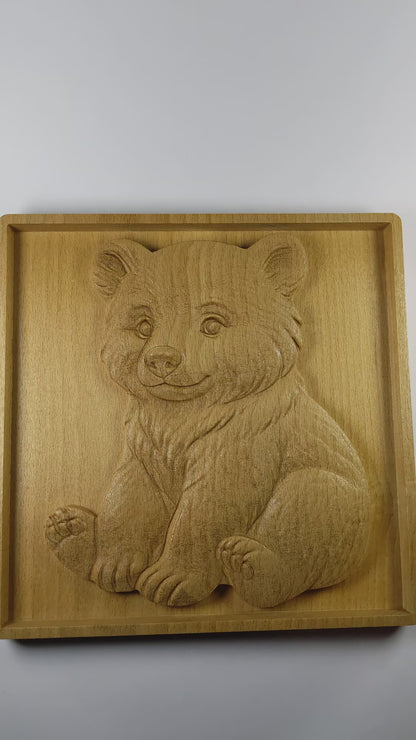 Video showing wooden wall art up close to see details of sitting bear cub and wood grain