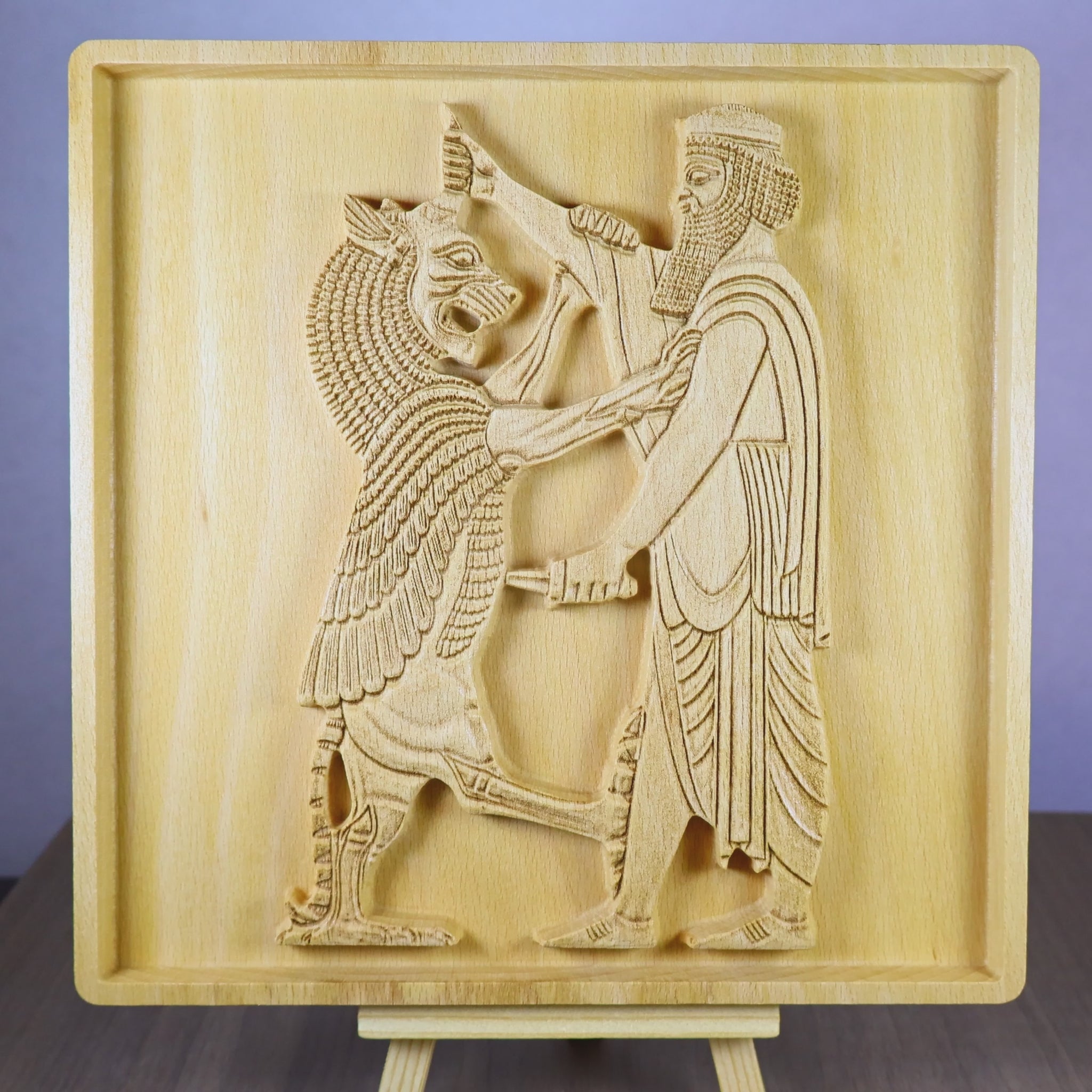 Rotating tabletop video of the Shahriar and the Lion wood relief, showing the front and angled side views of the Achaemenid-inspired Persian figure, lion scene, carved clothing and weapon details, raised relief depth, and natural beech wood finish.