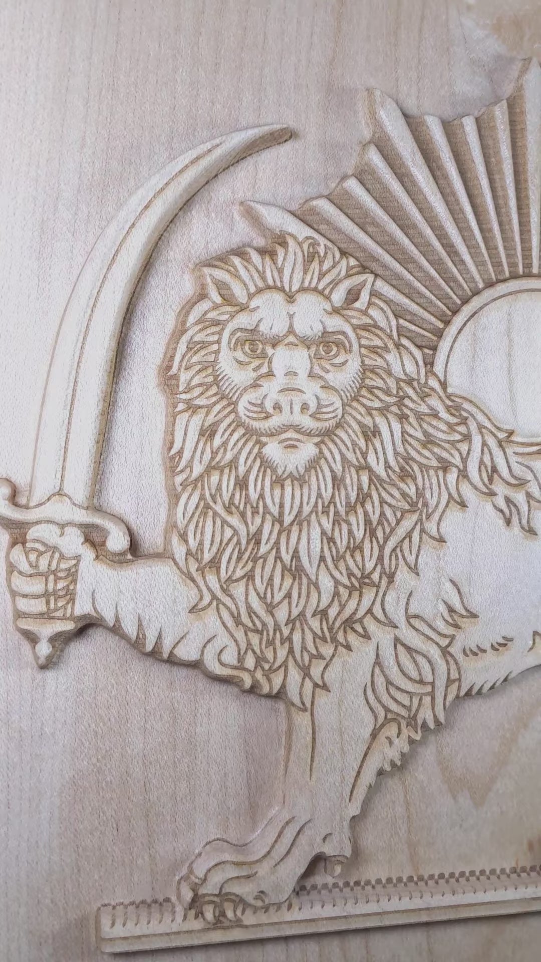 Video of Lion and Sun (Shir va Khorshid) hard maple wood relief rotating side to side, showing 3D carved depth, raised lion figure, curved saber, sunburst rays, and laser-engraved detail, Persian wall art